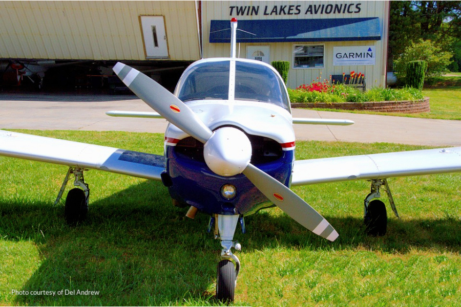 An image of a small engine airplane parked in front of Twin Lakes Avionics